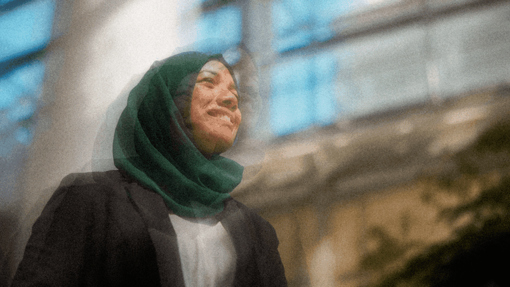 Woman smiling while standing in a modern building atrium