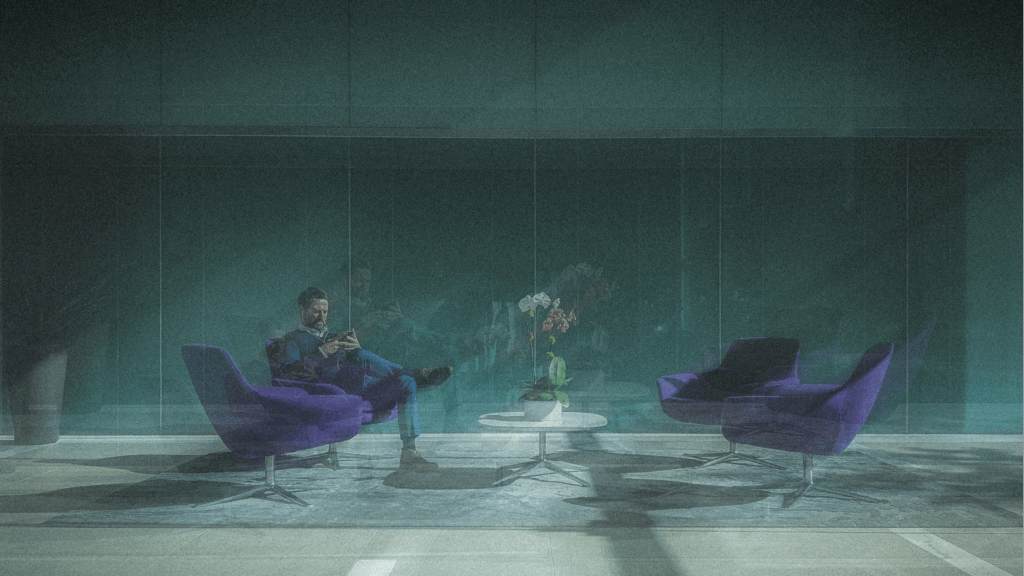 Man in suit using tablet in stylish lobby